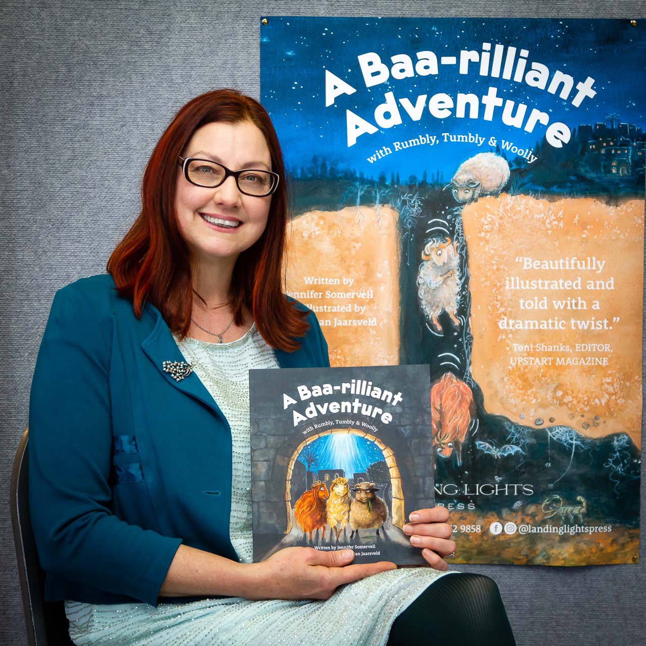 Illustrator posing with book